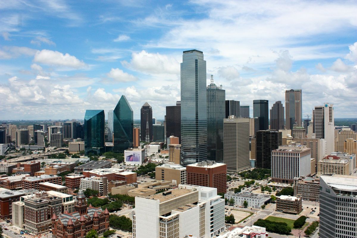 Downtown Dallas buildings under a clear blue sky