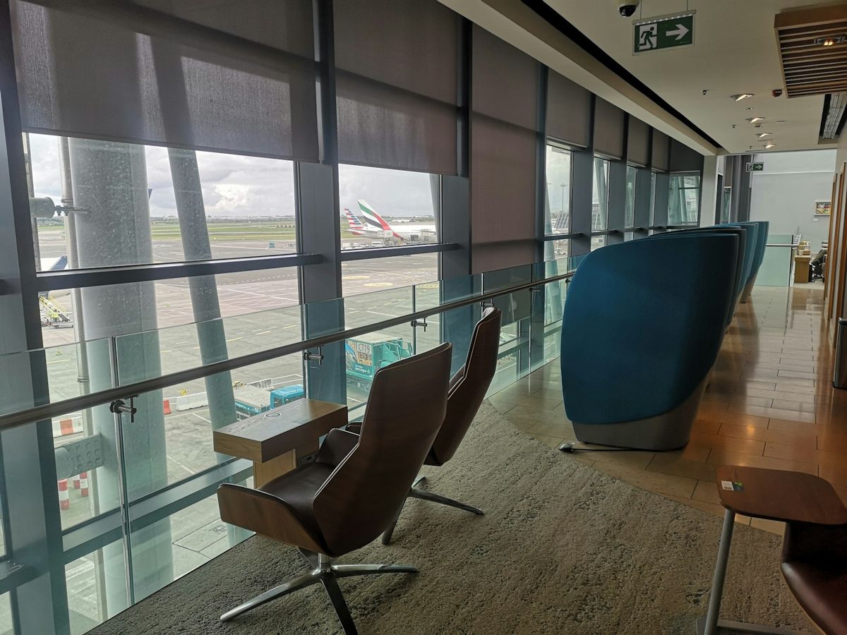 Passengers in Dublin Airport terminal lobby with tarmac view