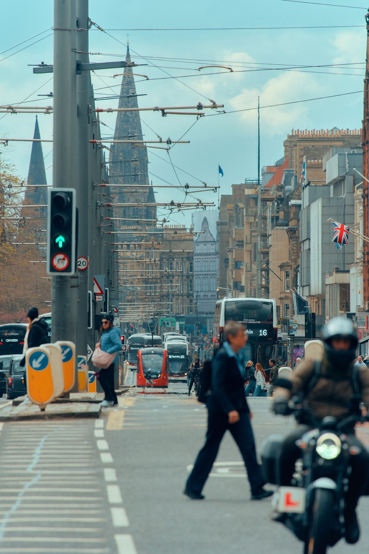 Busy Edinburgh street with trams and buses in the city centre