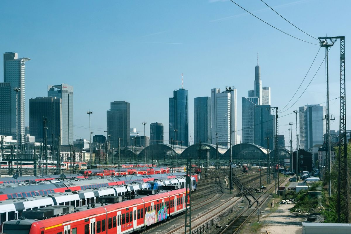 Multiple trains at Frankfurt station with city skyline