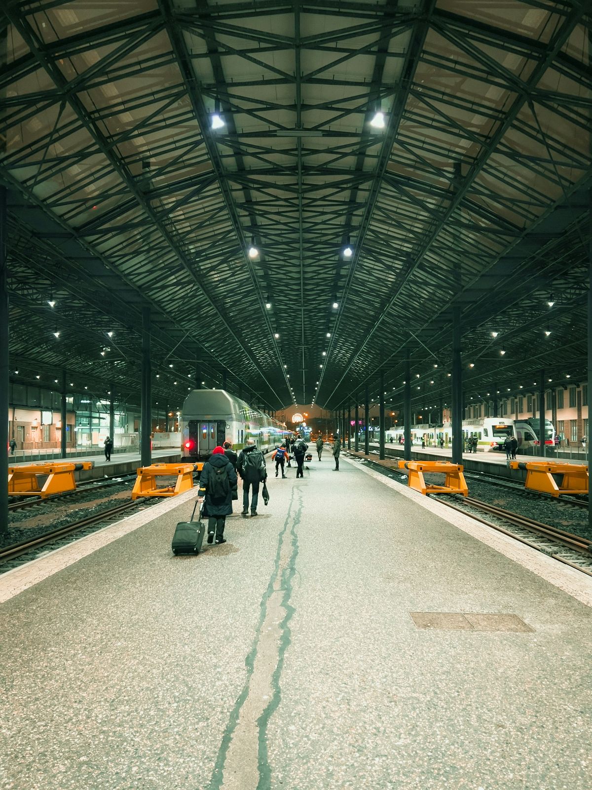 Helsinki train station with train on tracks and passengers