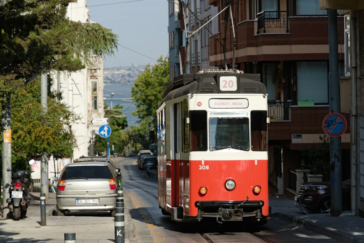 Red Istanbul tram traveling down a busy city street