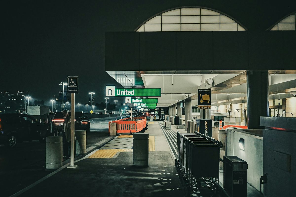 Airport terminal entrance at night with United Airlines signage
