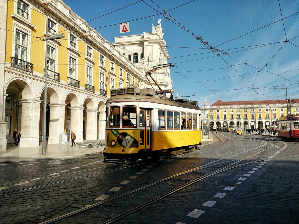 Yellow Lisbon tram on city street