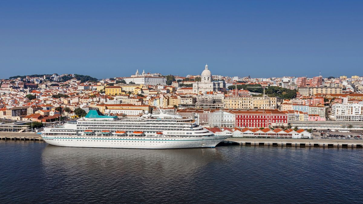 Cruise ship docked in Lisbon harbor with the city in the background