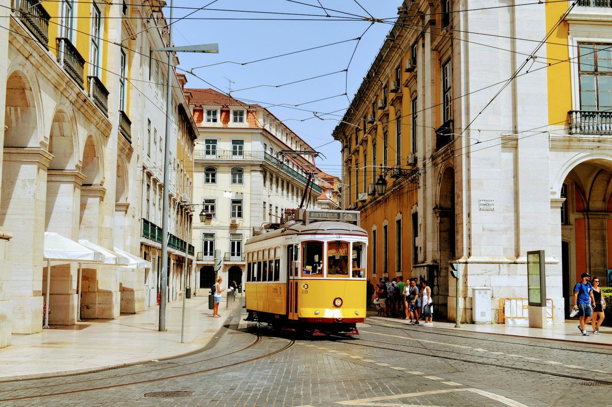 Yellow tram on a street in Lisbon