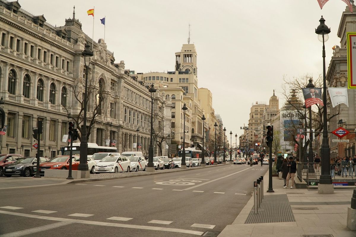 City street lined with tall buildings in Madrid