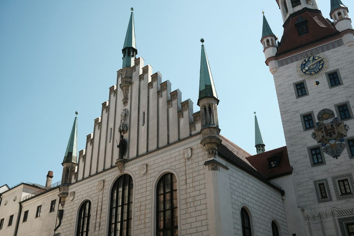Large white town hall building with a clock tower in Munich