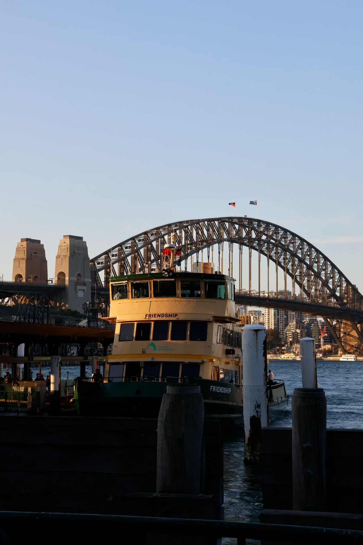 Ferry docked near the Sydney Harbour Bridge at sunset