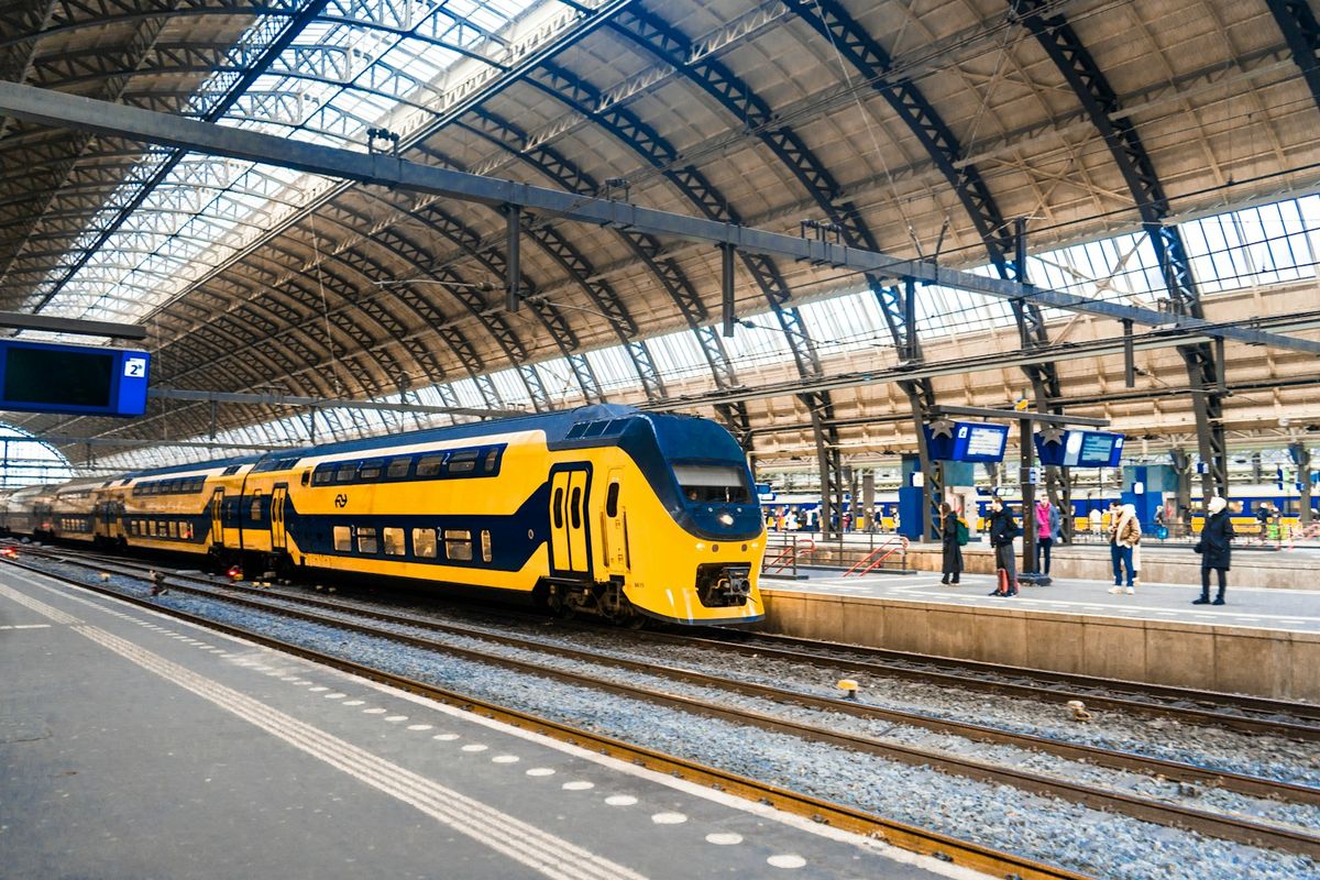 Yellow and blue NS train pulling into a Dutch train station