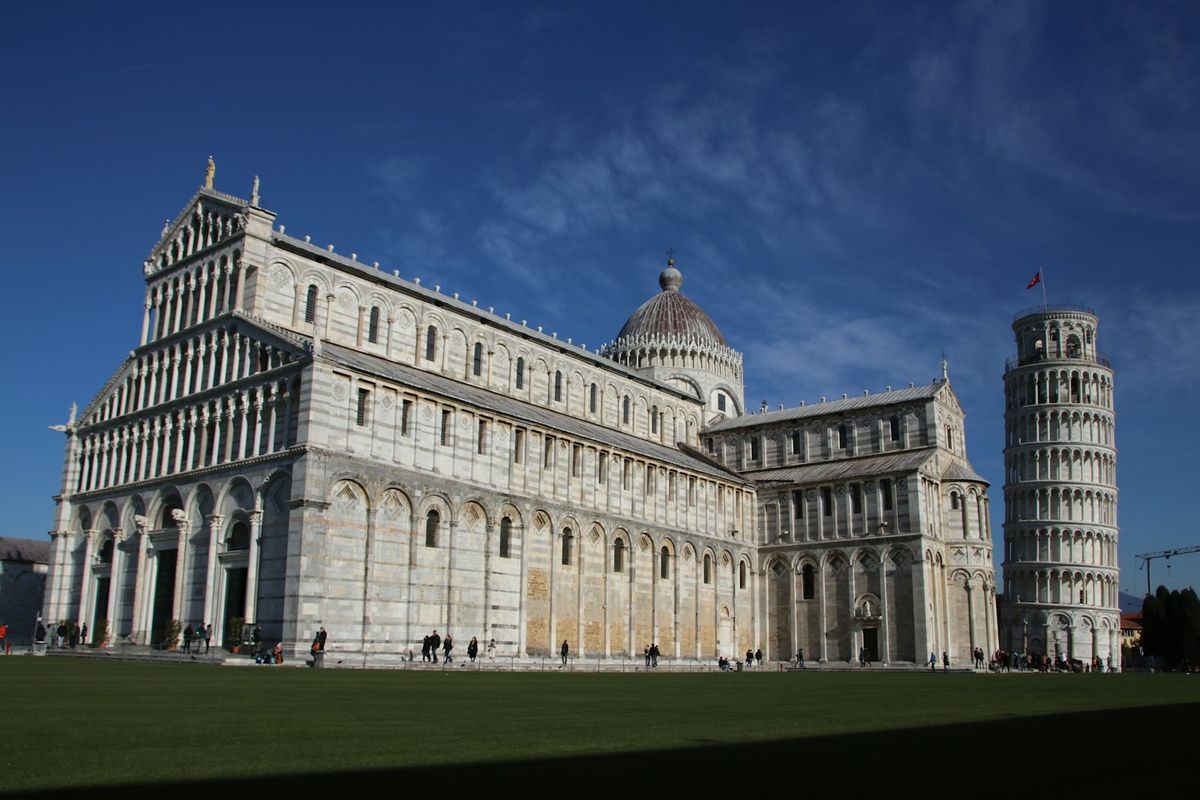 White marble building of Pisa cathedral under blue sky