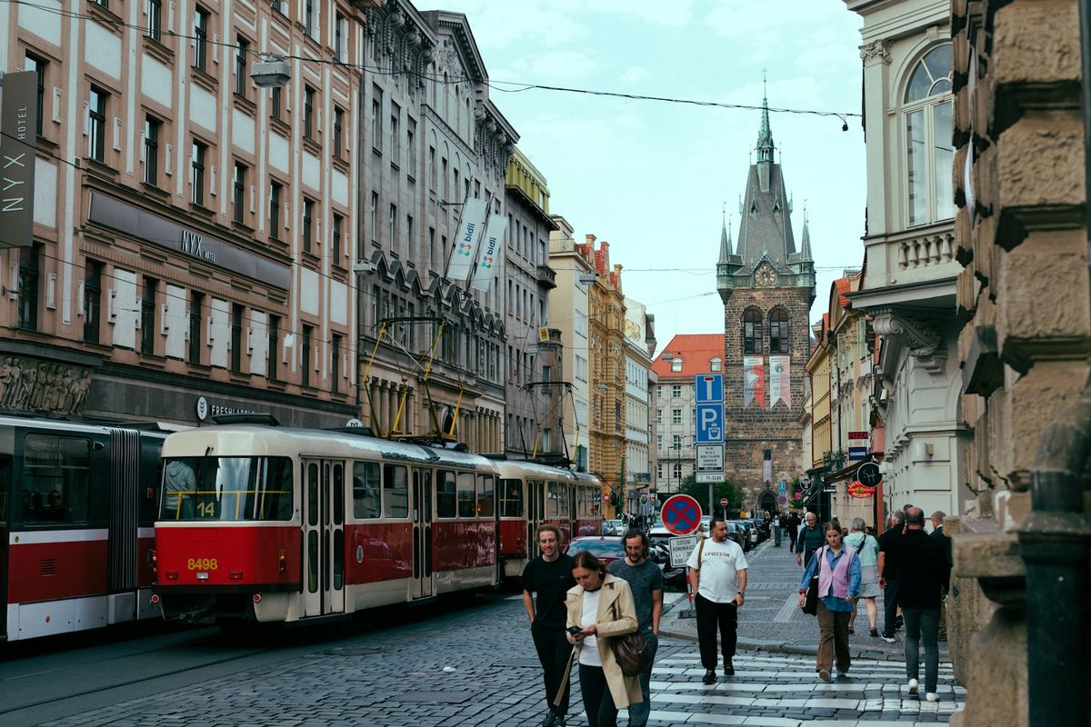 Trams and pedestrians on a Prague city street
