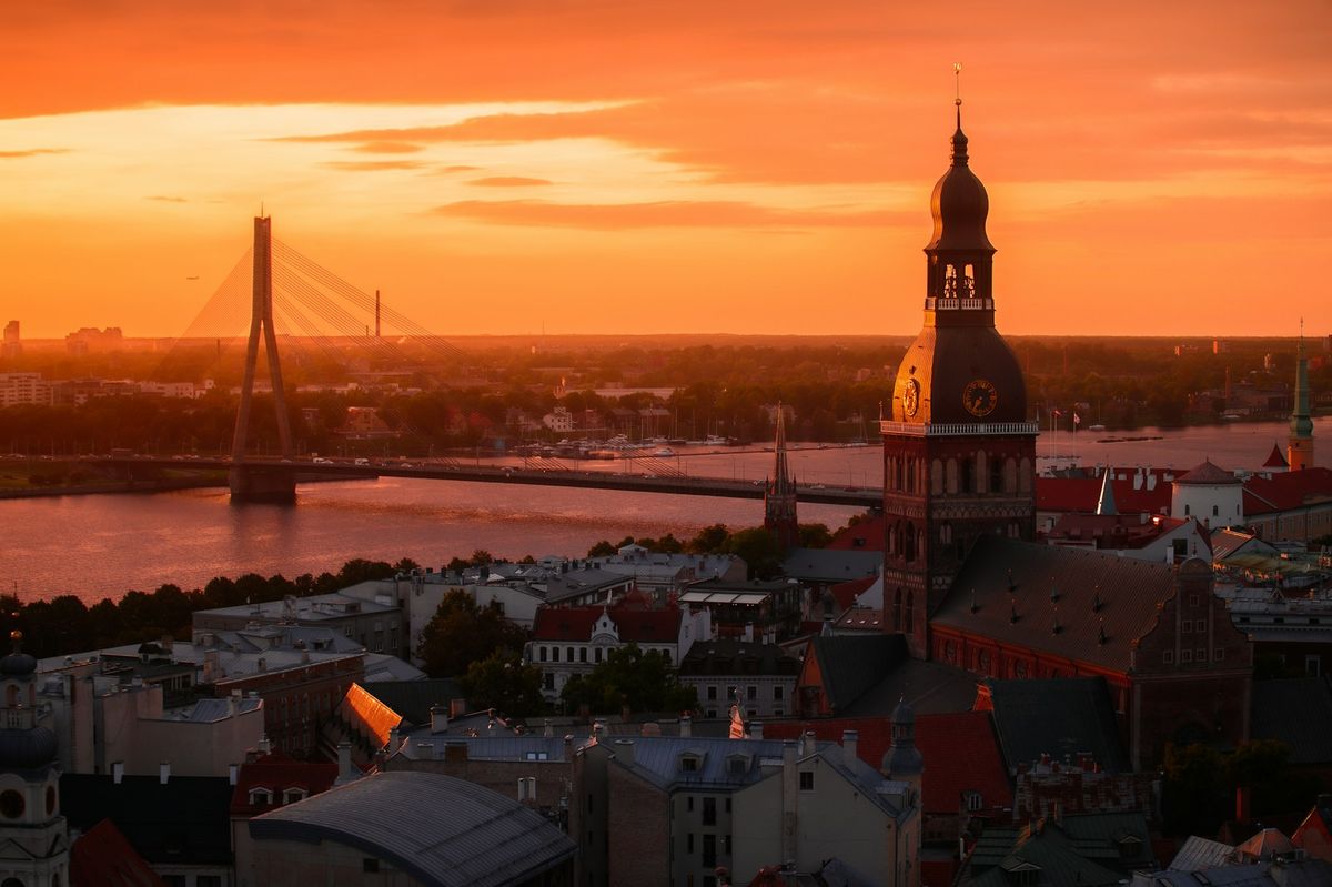 Riga cityscape with river and bridge at golden hour