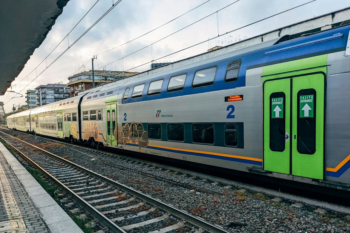 Passenger train on railway tracks in Rome, Italy