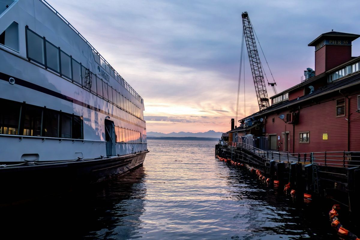 Cruise vessel docked at Pier 55 on the Seattle waterfront at sunset