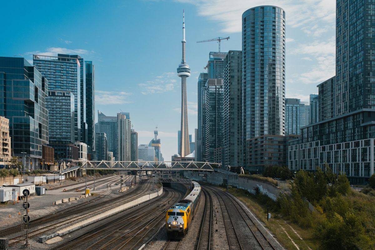 Train traveling through Toronto with skyline