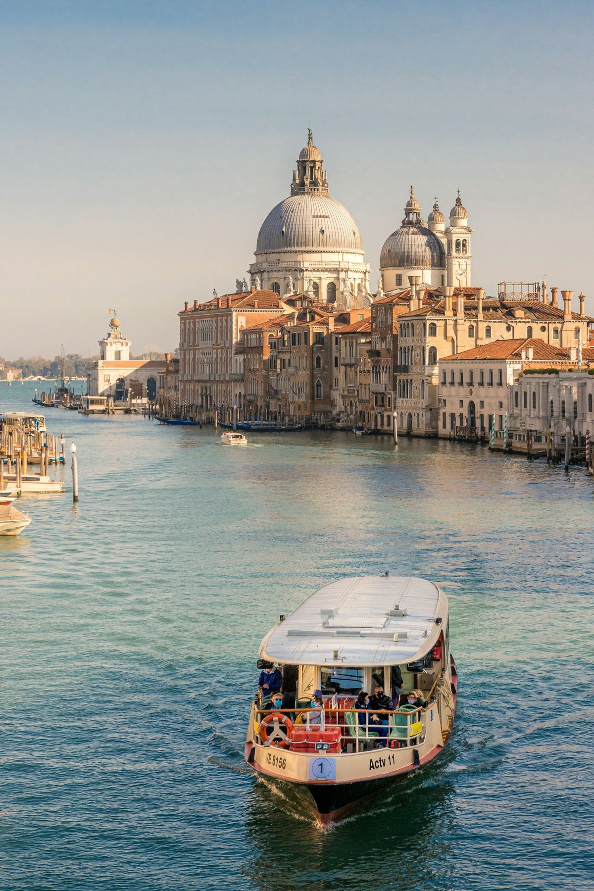 Vaporetto water bus with passengers on a Venice canal