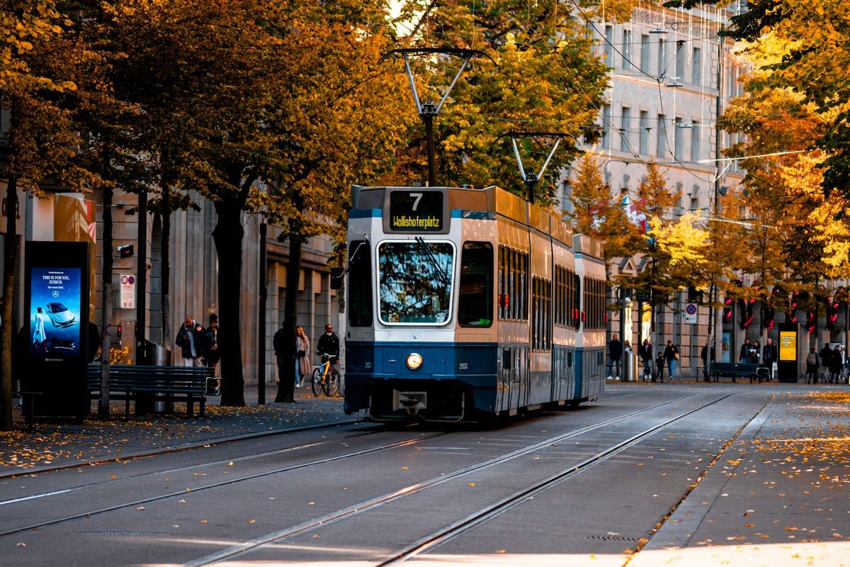 Blue and white Zurich tram on a city street in Switzerland