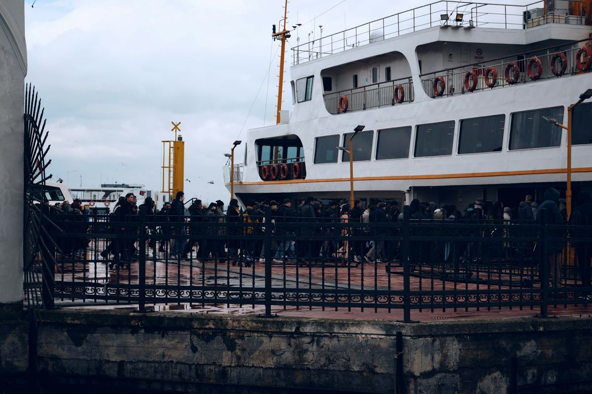 People waiting to board a passenger ferry at a port terminal