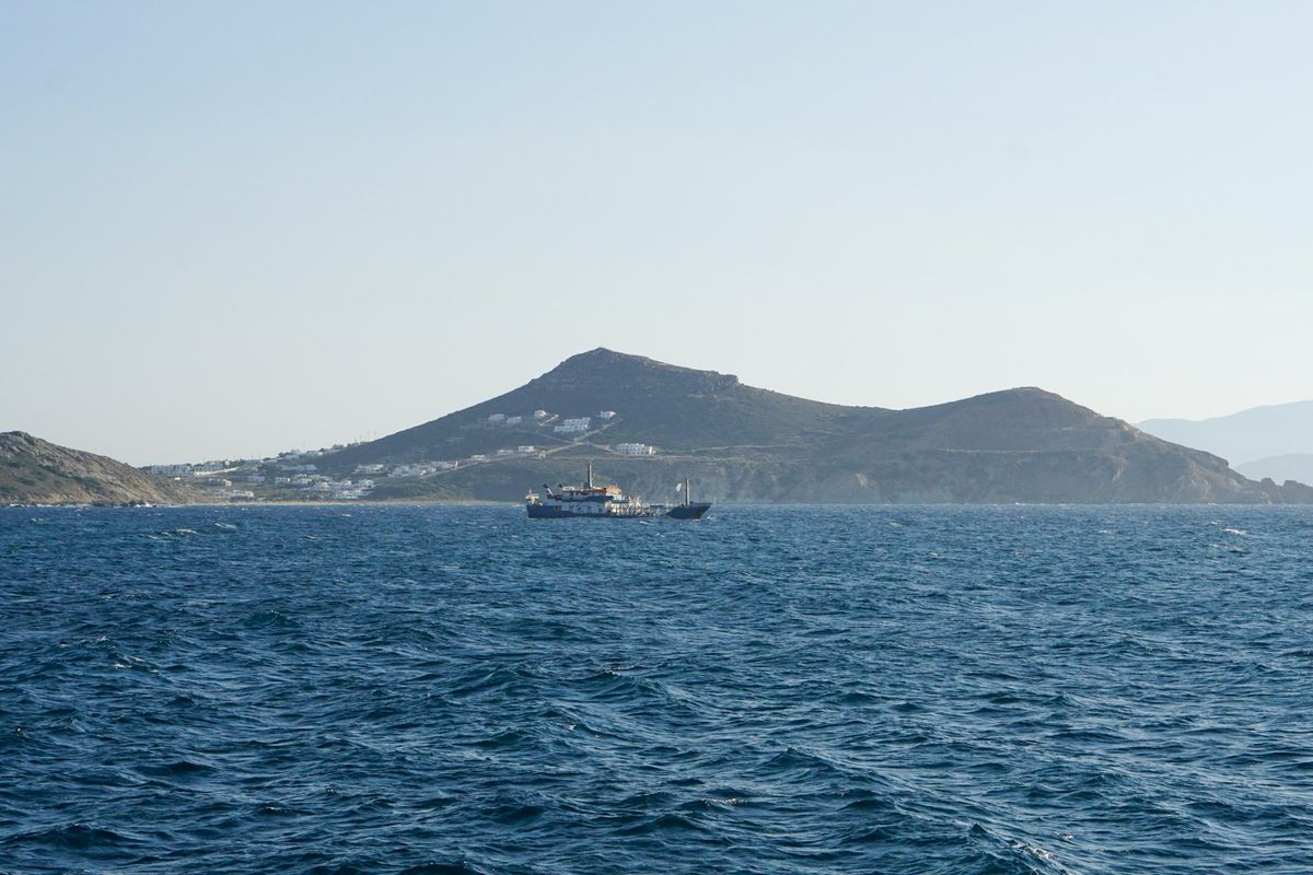 Ferry boat approaching a Greek island in the Cyclades