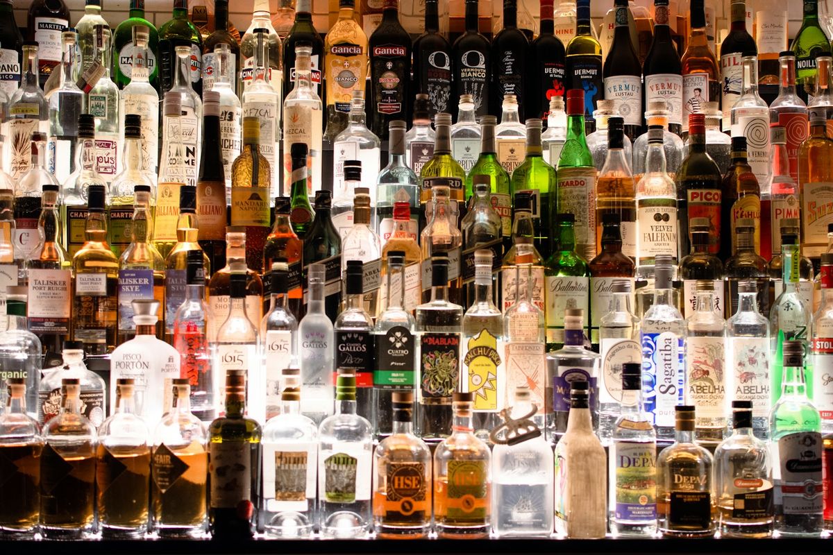Duty-free style shelves stocked with liquor, wine and whisky bottles