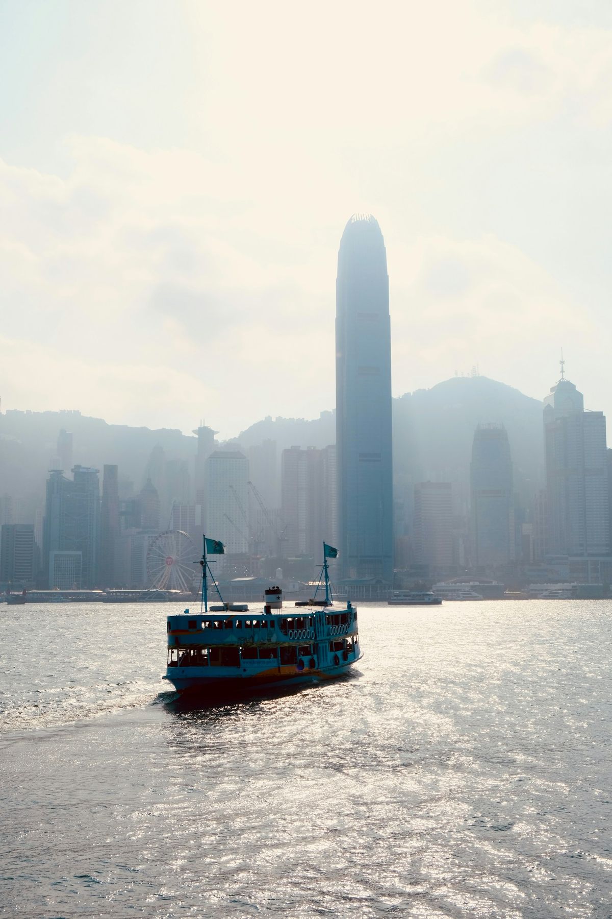 Ferry boat sailing across Victoria Harbour with the Hong Kong skyline