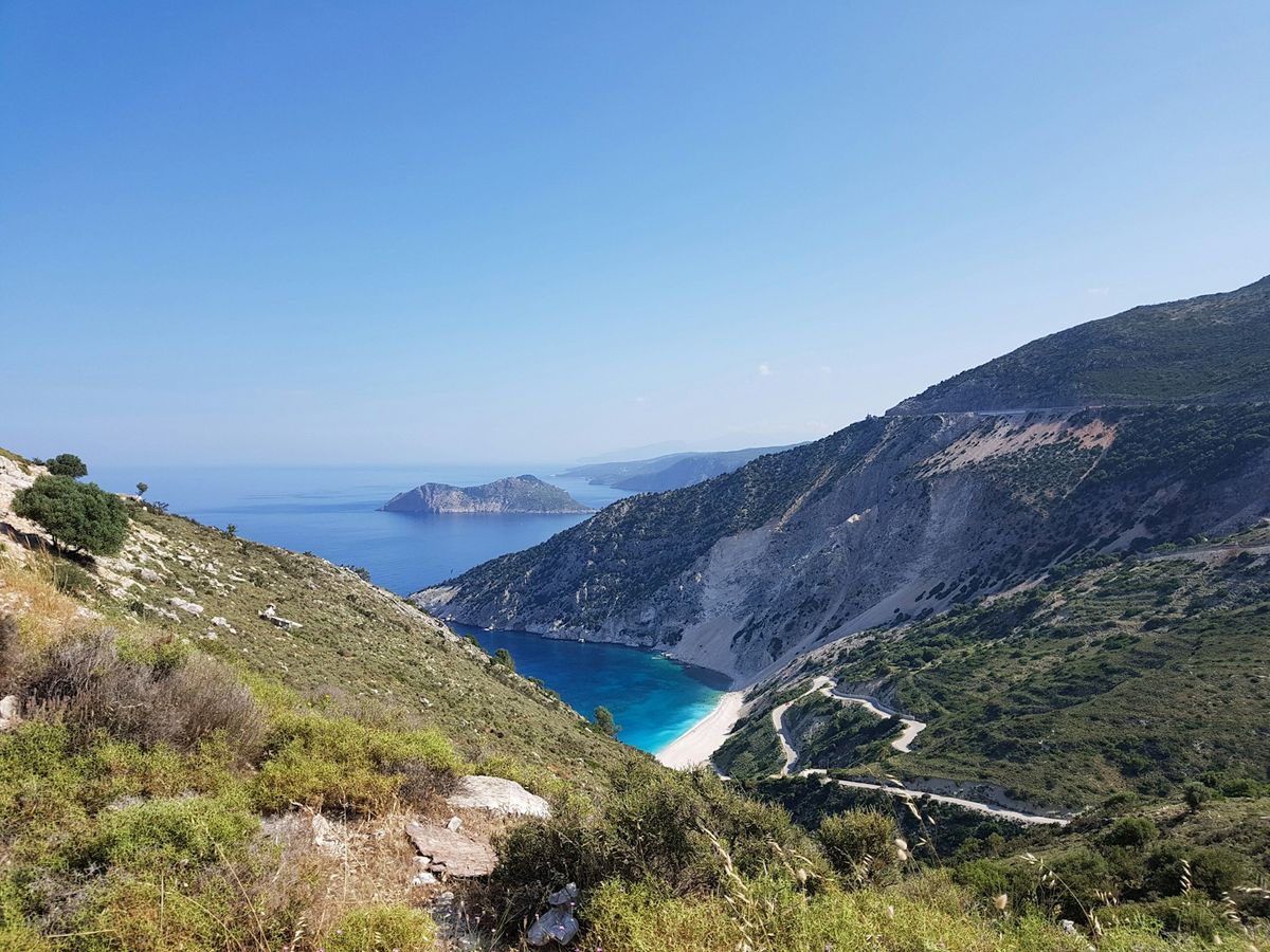 Green mountain beside turquoise sea in the Ionian islands