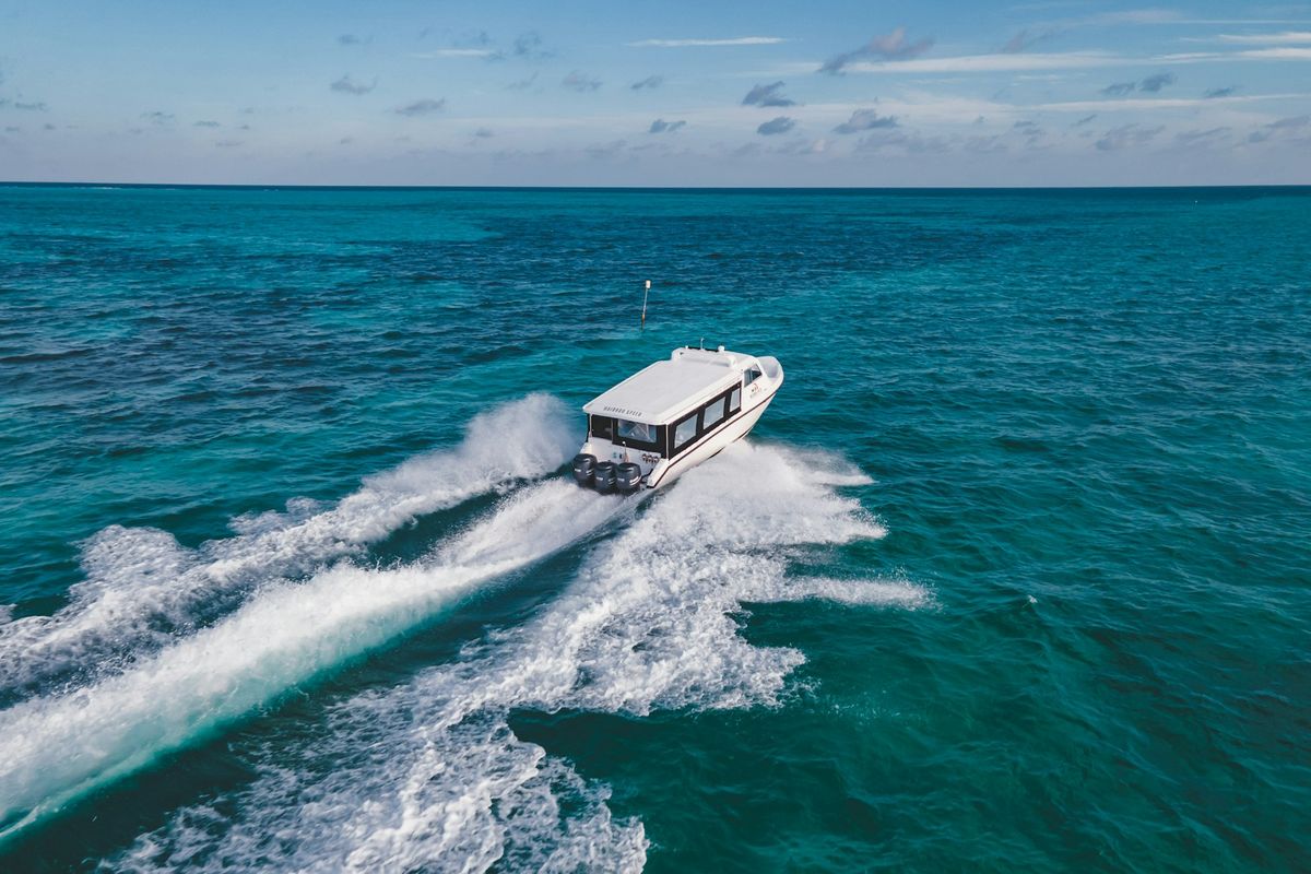Speedboat racing through turquoise tropical sea