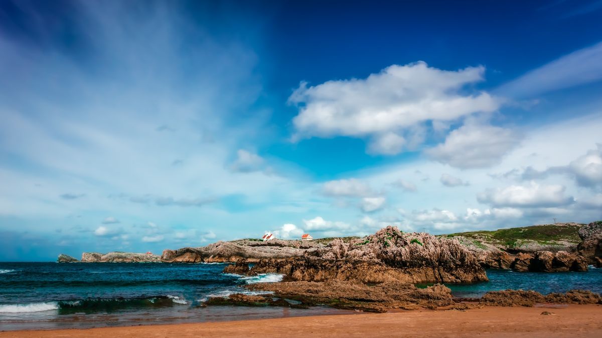 Rocky Cantabrian coastline near Santander Spain under blue sky