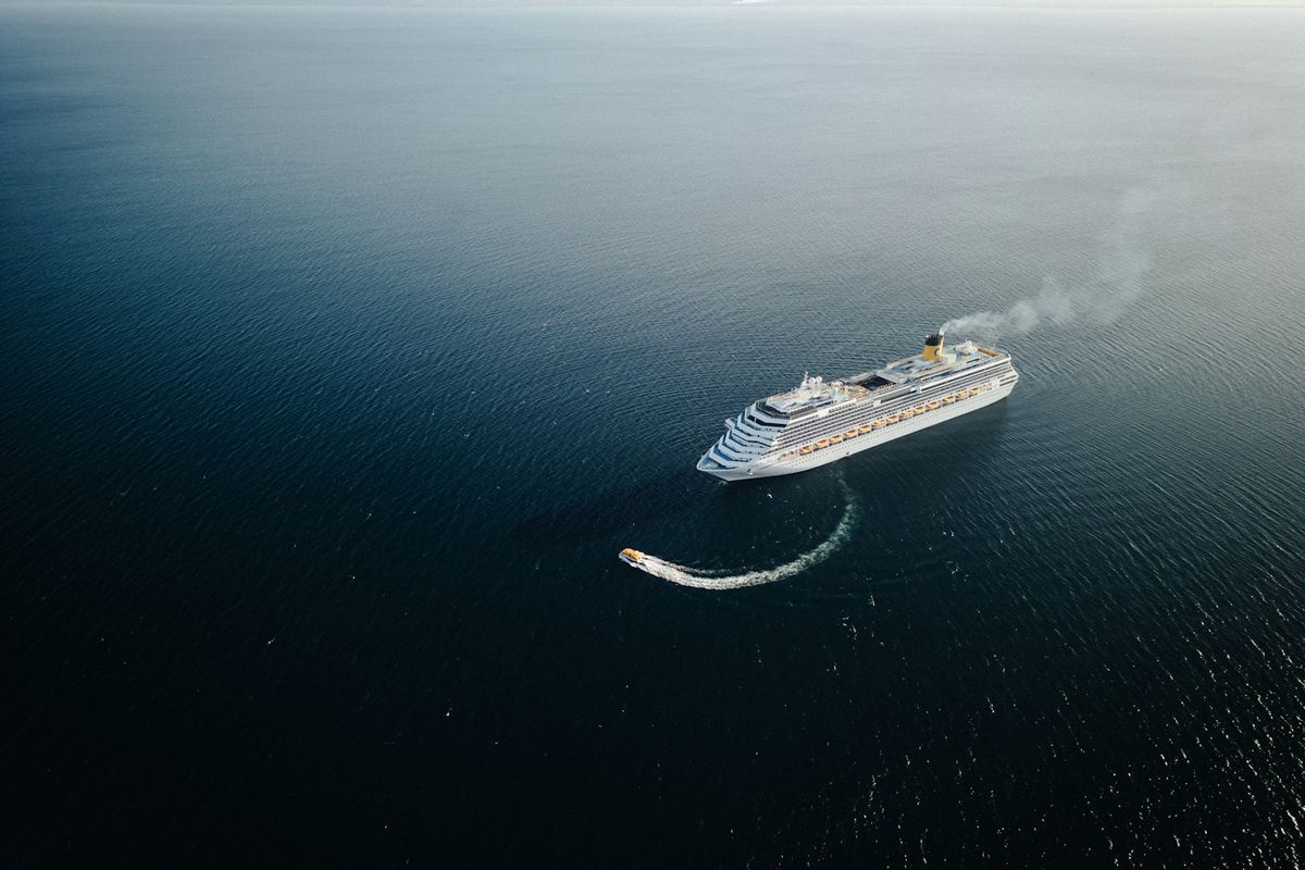Large white passenger ferry ship sailing on the ocean