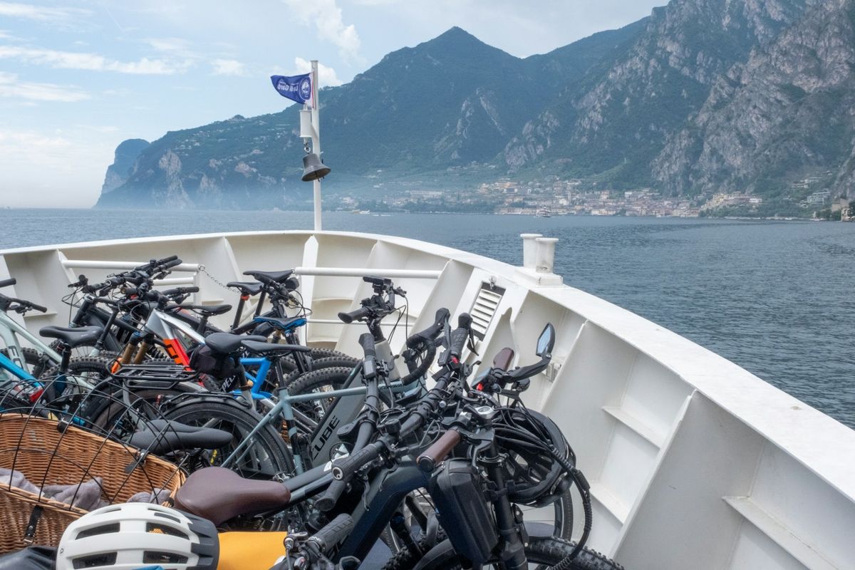 Ferry transporting bicycles across a scenic lake with mountains