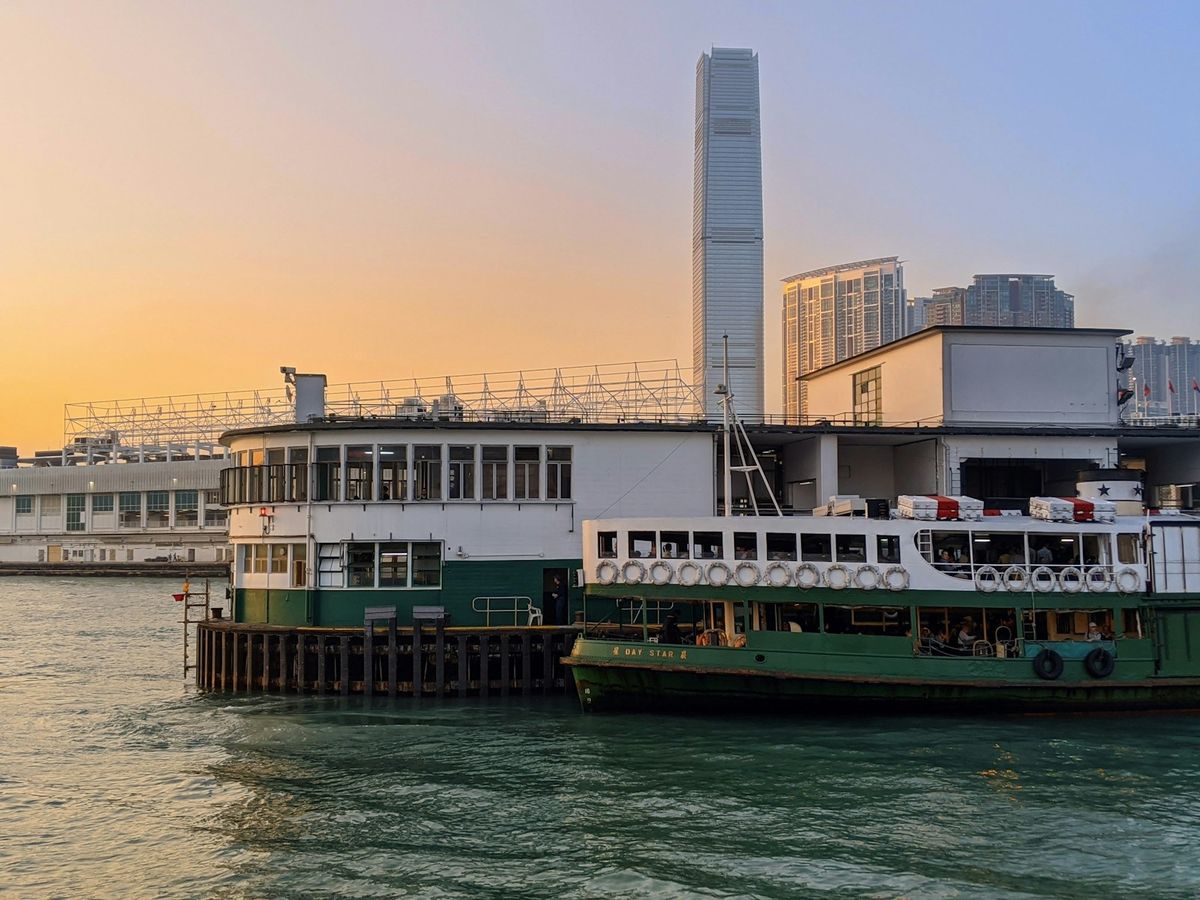 The Star Ferry docked in Hong Kong with the city skyline behind