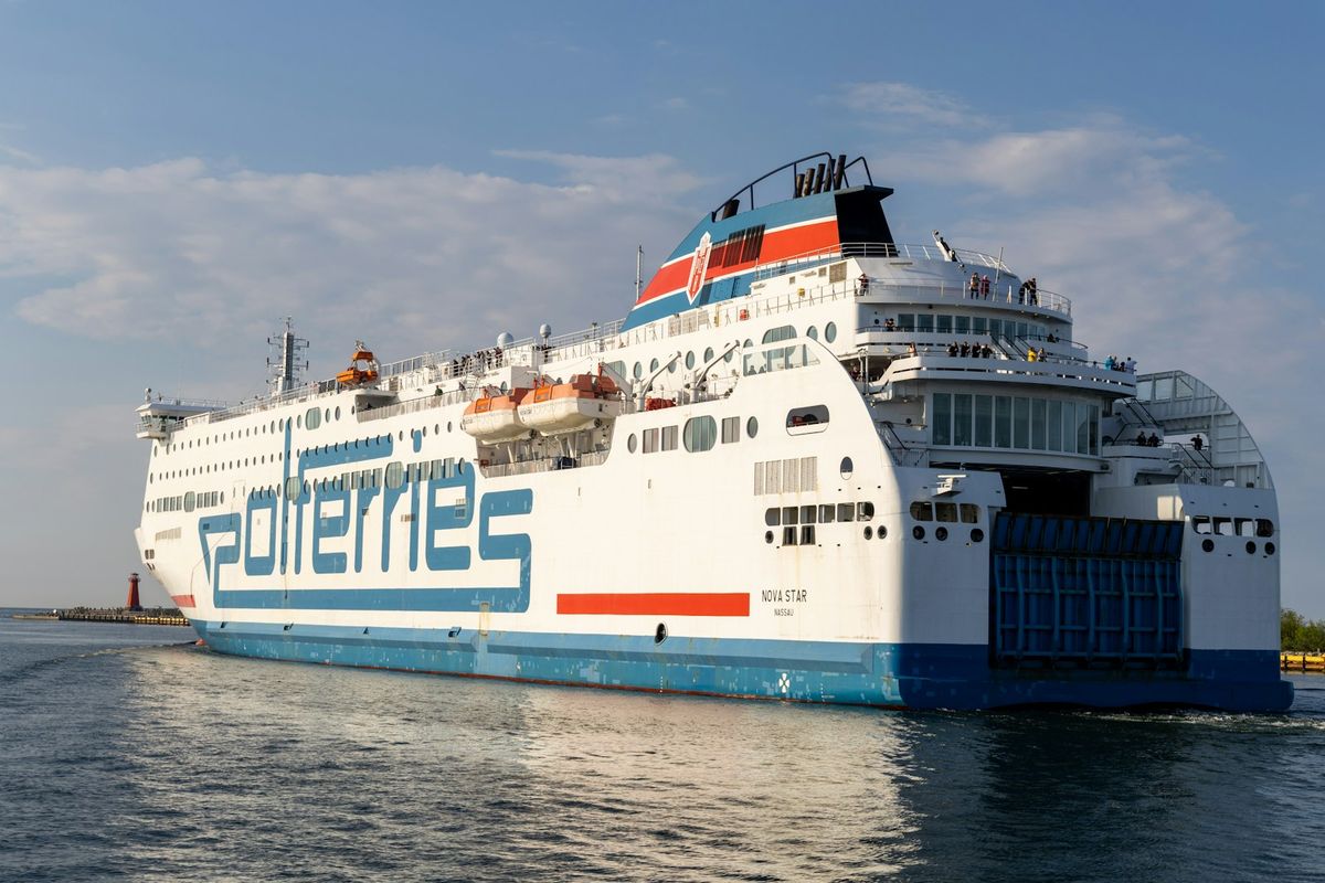 Large white passenger ferry sailing on calm water