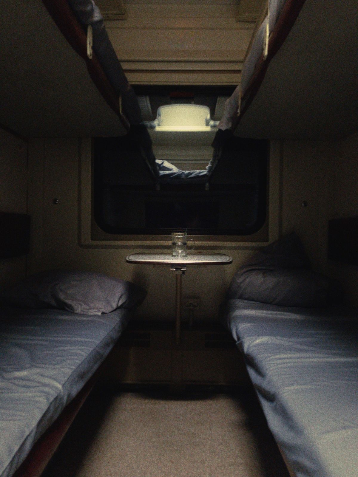 Table beside sleeping berths in a train sleeper car