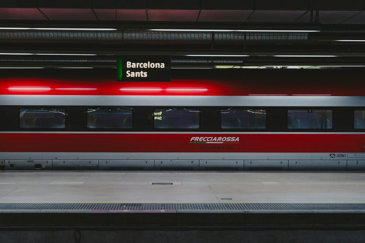 Red and silver AVE high-speed train at a Spanish station platform
