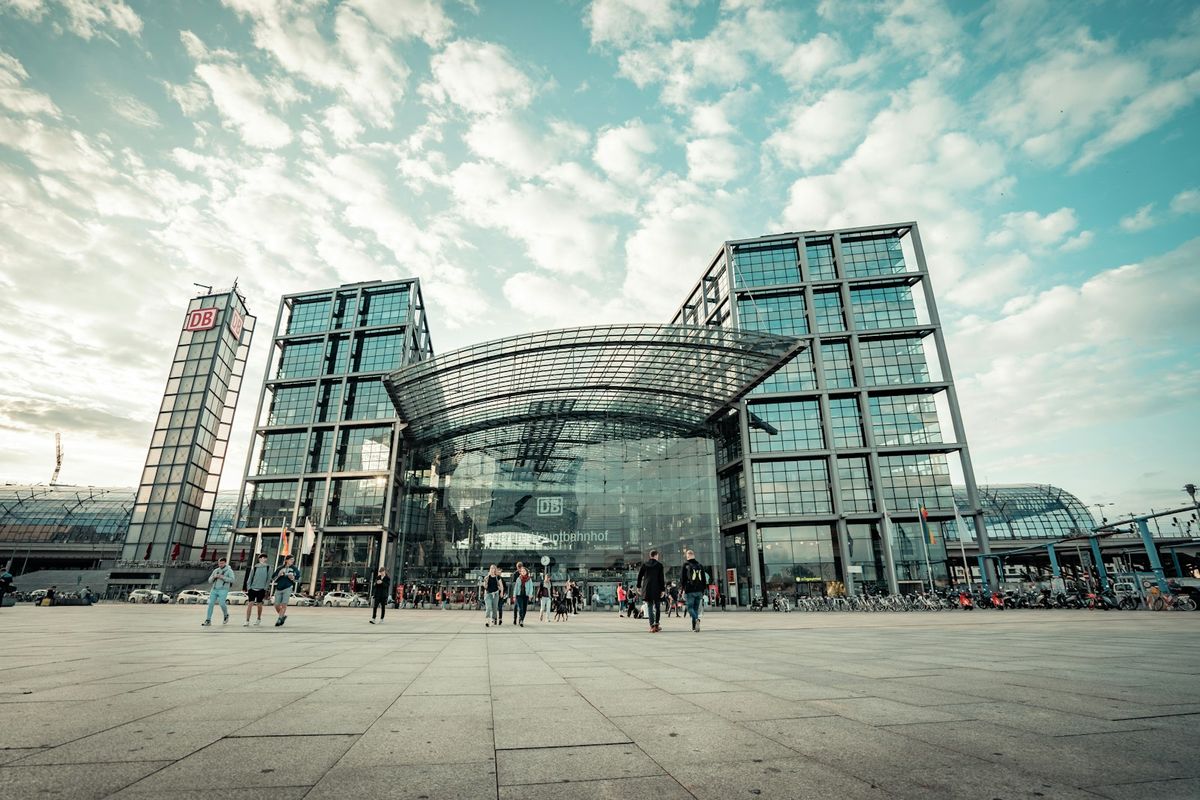 People walking near the glass facade of Berlin Hauptbahnhof station
