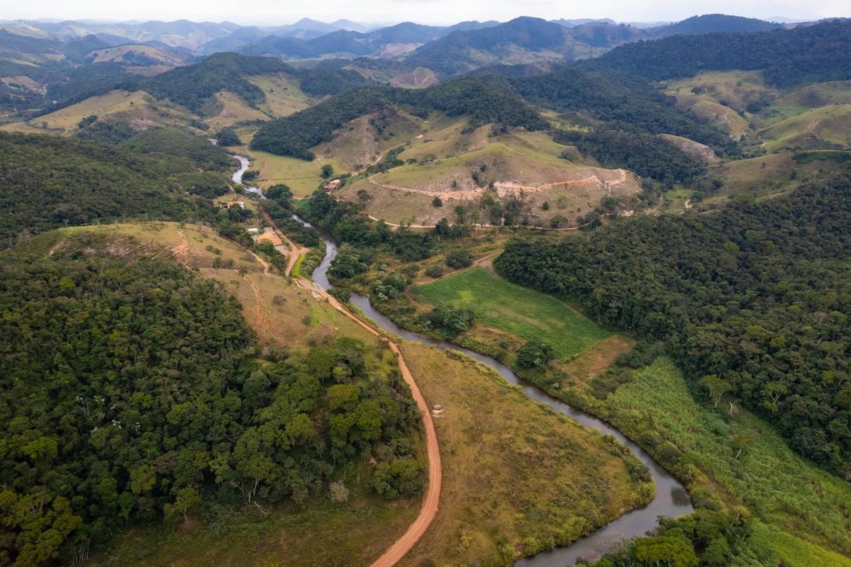 A river winding through the lush green Atlantic rainforest valley in Brazil