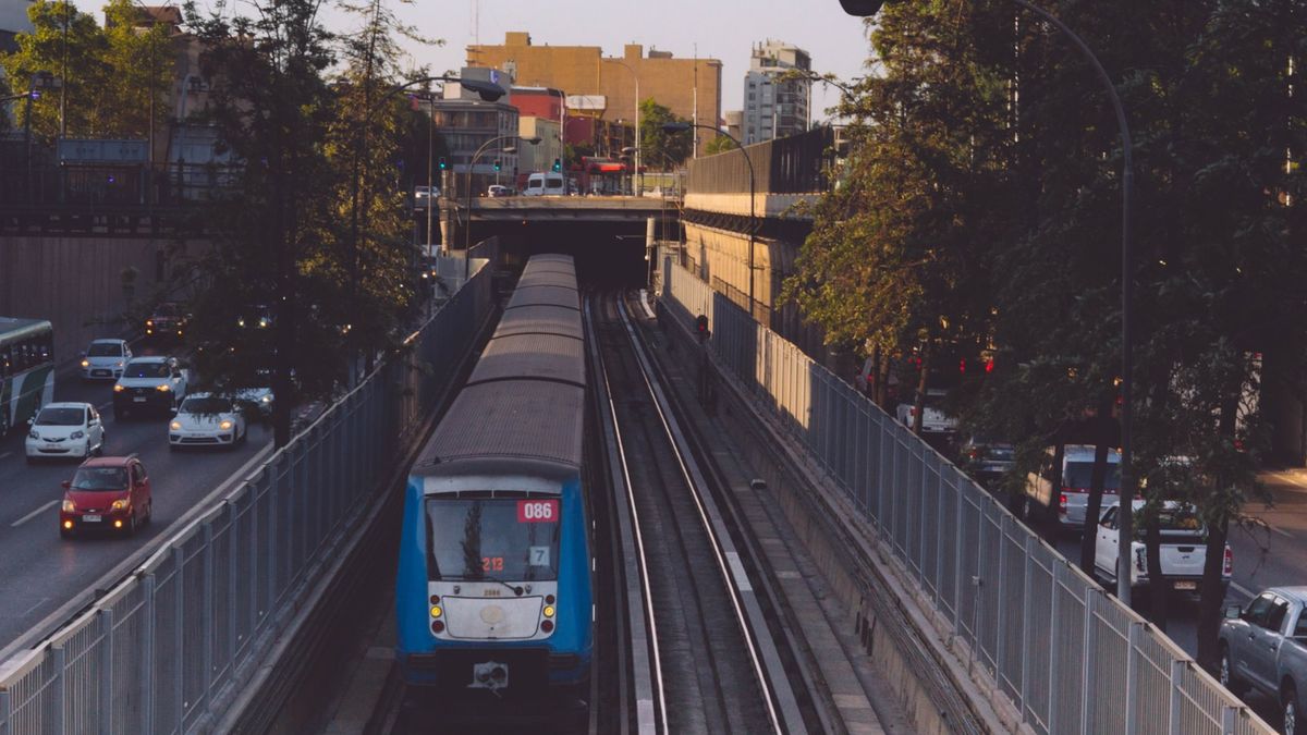 A blue and white train traveling in Chile