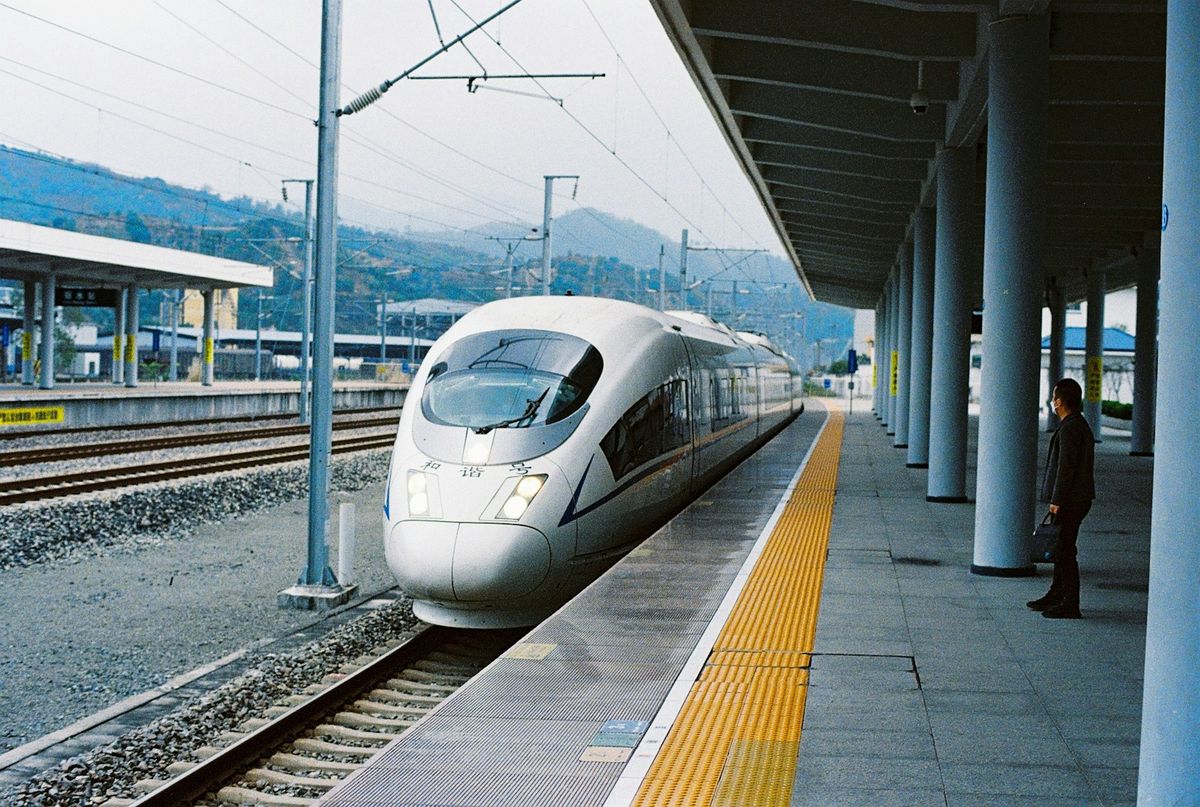 White bullet train on railway tracks in China