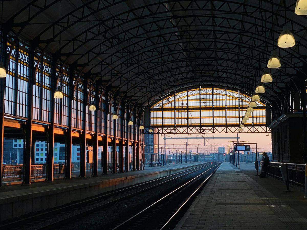 Busy European train station with trains on platform