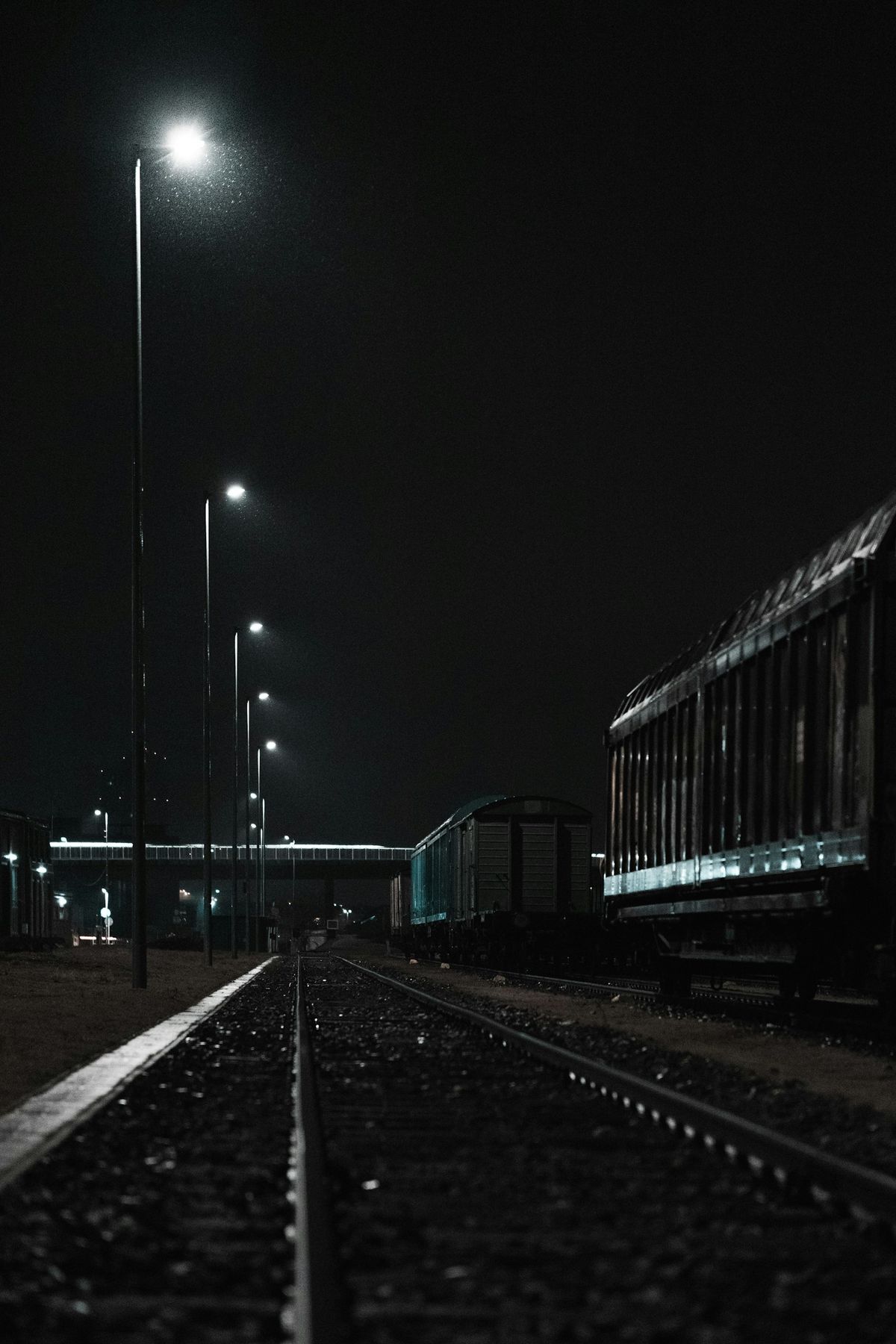 Train station lit up at night with platforms