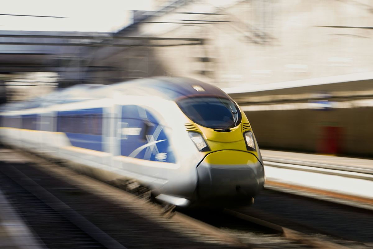 High-speed train departing a European railway station platform