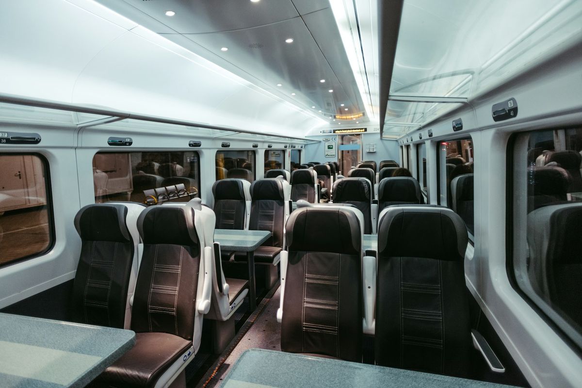 Rows of seats with dining tables inside a European train