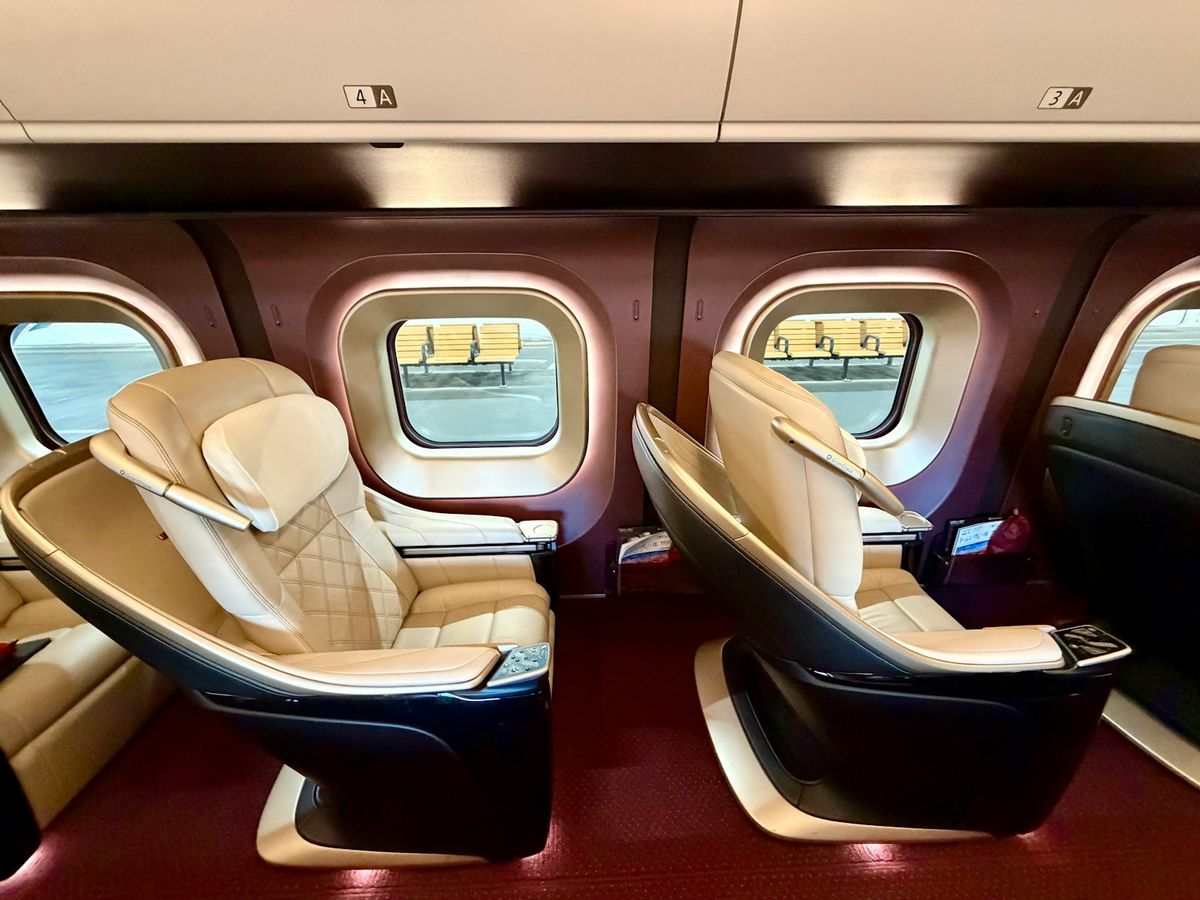 Luxurious train seats with plush upholstery and large windows