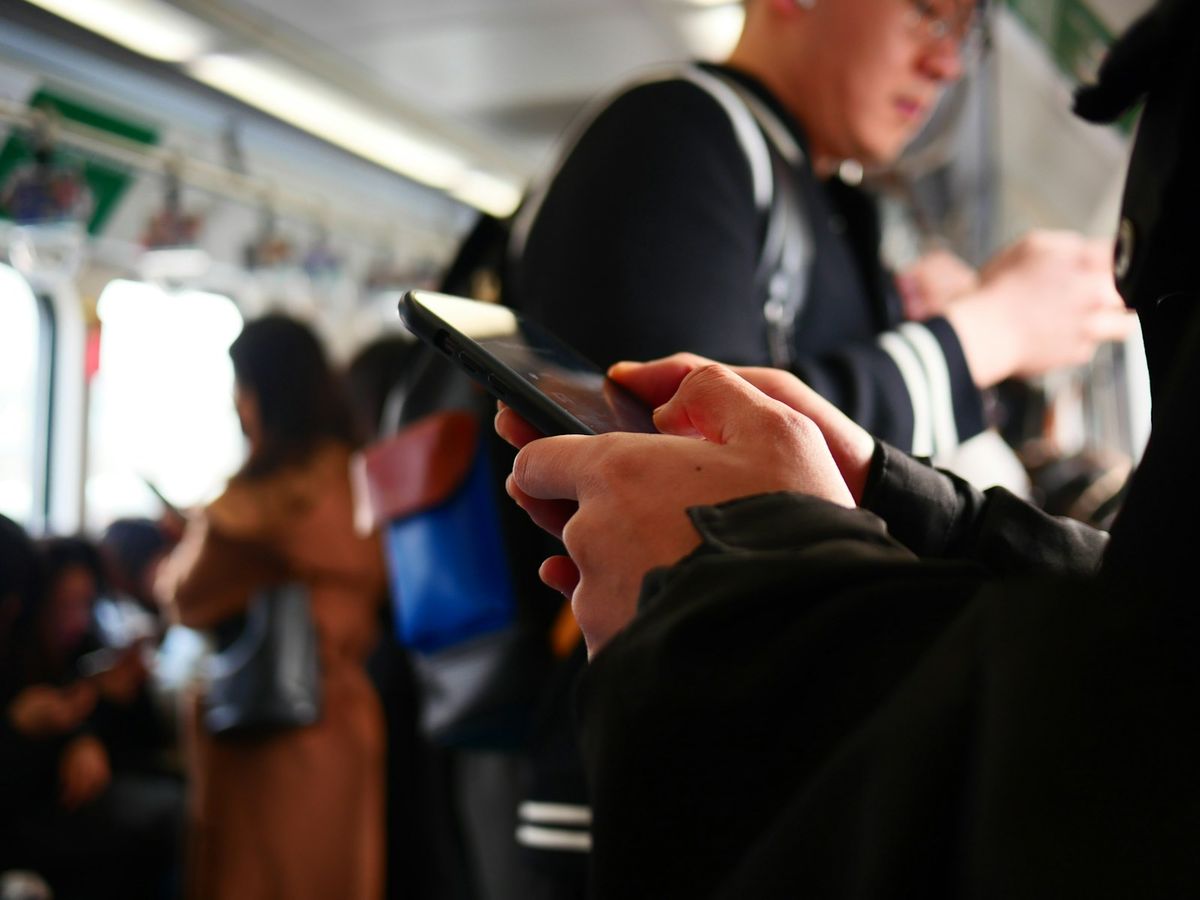 Person using a smartphone while travelling on a train