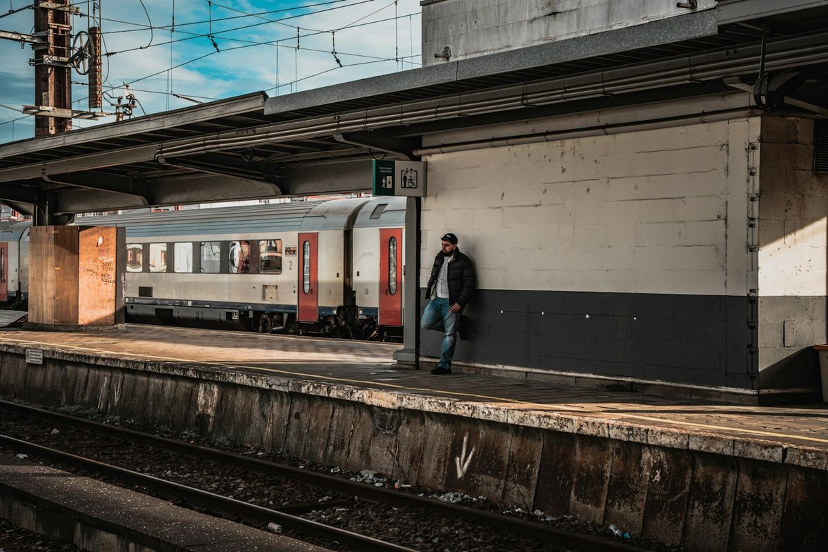 Traveler with backpack standing on a European train platform
