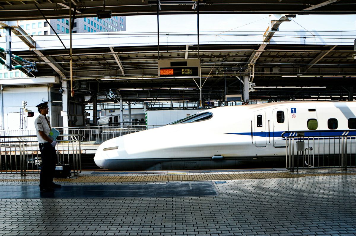White Shinkansen bullet train resting on station tracks in Japan
