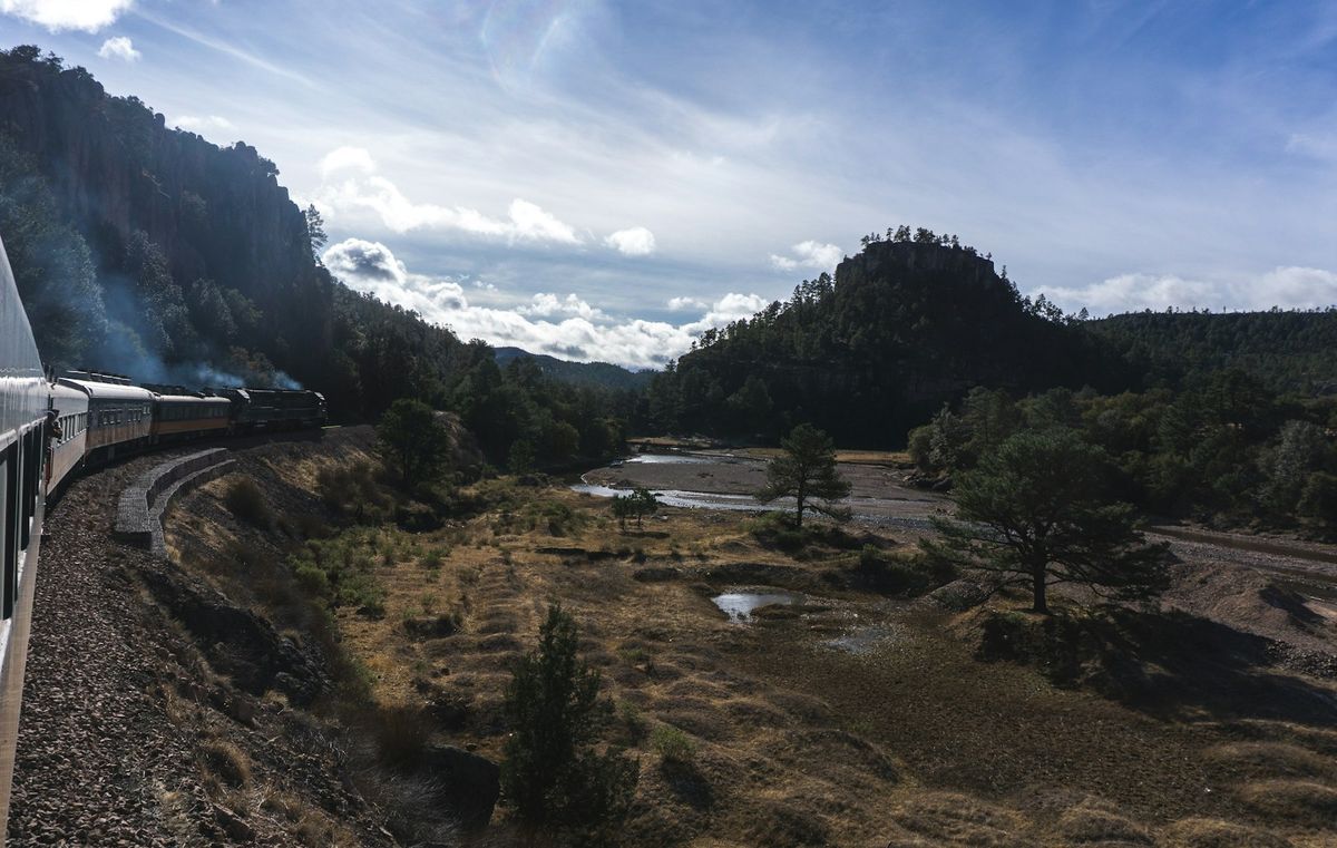 Train traveling through the dramatic canyon landscape of Mexico's Copper Canyon