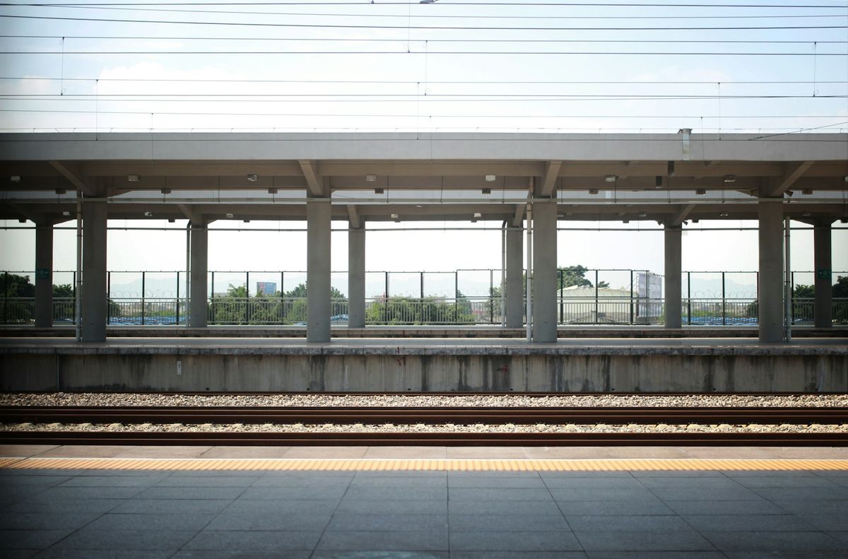 Vacant railway platform with concrete pillars