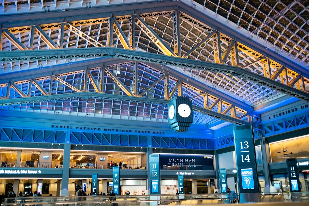 People walking inside Moynihan Train Hall in New York